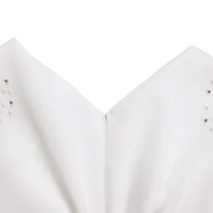 Detail of elegant white V-neck evening gown featuring pearl and silver bead embellishments.
