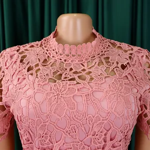 Detailed macro view of pink hollow-out lace neckline on an elegant short-sleeve jumpsuit