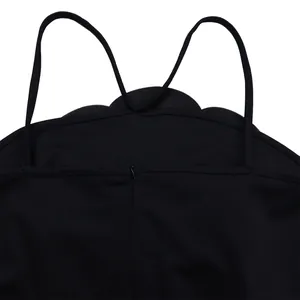 Close-up of black sleeveless jumpsuit with scalloped floral edges and thin straps detail