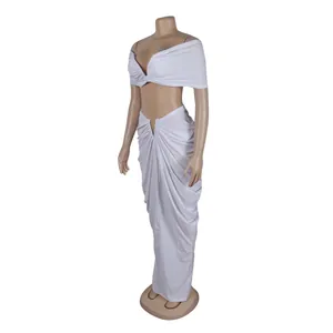 Detail view of white two-piece set with pleated off-shoulder top and floor-length skirt.