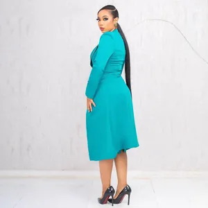 Elegant teal two-piece suit set featuring a waist-cinched blazer and skirt