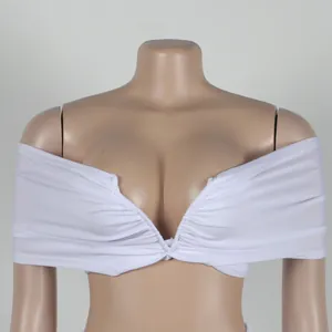 Close-up view of the pleated white fabric and deep V-neckline on this sexy crop top