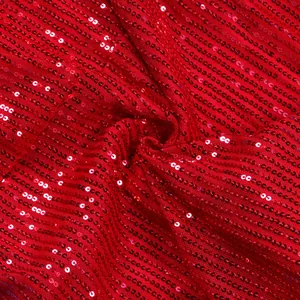 Detailed close-up showing the shiny red sequin texture and fine mesh material of the dress.