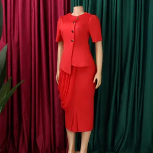 Detailed view of an elegant red two-piece suit with a ruffled pencil skirt and gold buttons