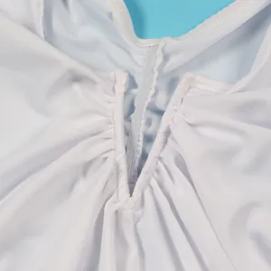Close-up of ruched detail and elastic stitching on white bodycon dress fabric