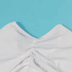 Detail view of the fine stitching and ruched design on this white elastic bodycon dress