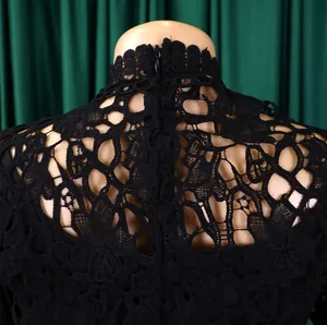 Detailed macro view of elegant black hollow lace pattern and back zipper on high-neck top