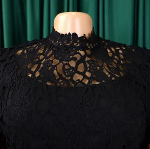 Close-up detail of black hollow lace neckline on an elegant high-waisted jumpsuit