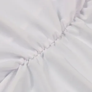 Macro view showing the detailed texture of the white elastic pleated fabric stitching.