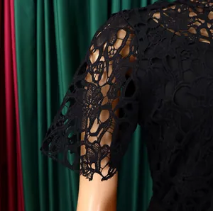 Close-up of black floral lace sleeve showing intricate cutout details and texture.