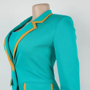 Detail shot of a turquoise blazer with yellow piping on an elegant commuter suit set.