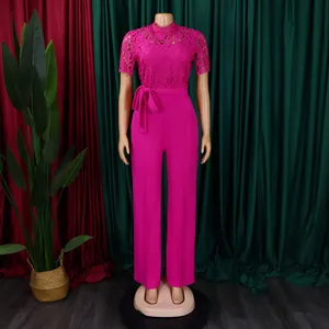 Detail view of a fuchsia lace hollow-out short sleeve jumpsuit with a high waist tie.