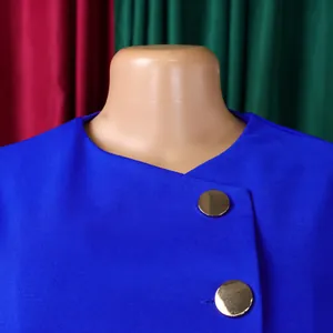 Close-up of elegant blue top fabric texture with large decorative gold buttons