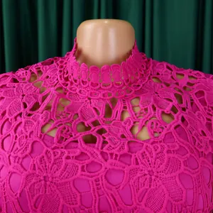 Close-up detail of fuchsia hollow lace pattern and scallop high neck collar of the jumpsuit