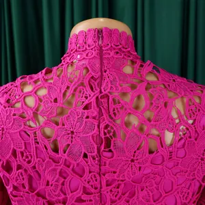Close-up of pink hollow-out floral lace detail on back of jumpsuit with hidden zipper