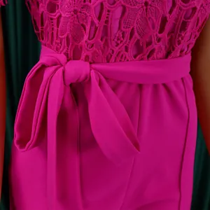Detailed macro view of fuchsia floral lace bodice and waist bow tie on elegant jumpsuit