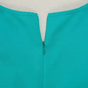 Detail view of an invisible back zipper on a turquoise elegant commuter vest dress.