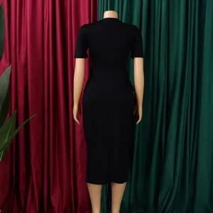 Detailed back view of elegant black two-piece skirt set on mannequin with curtains