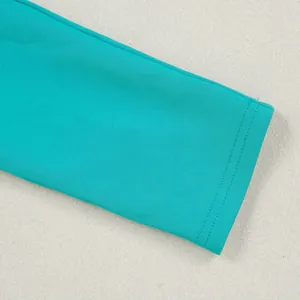 Close-up detail of the teal elastic fabric and neat double-row stitching on the sleeve