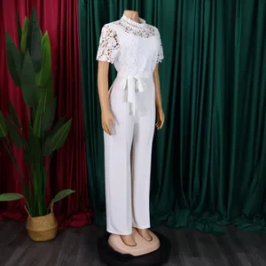 Elegant white lace hollow-out short sleeve high waist wide leg jumpsuit on mannequin.
