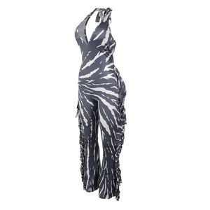 Detail view of zebra print halter jumpsuit featuring side fringe and backless design.