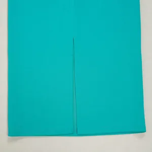 Close-up detail of the slit design on the back of the elegant teal commuting skirt.
