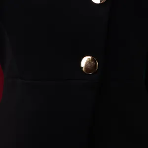 Detailed close-up view of a chic black African fashion set featuring a gold button accent