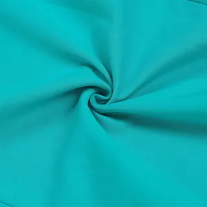 Macro view showing the fine texture and spiral folds of turquoise elastic fabric