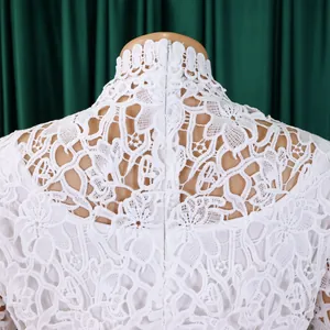 Detailed view of the intricate white floral lace pattern and back zipper of a high-neck jumpsuit
