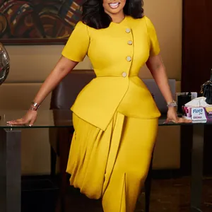 Detail view of yellow African fashion two-piece set with peplum top and pencil skirt.