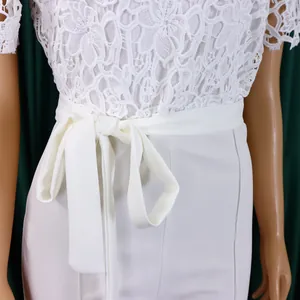 Detailed macro view of white lace hollow out jumpsuit featuring an elegant high waist tie