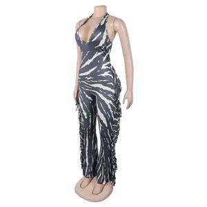 Close-up view of zebra print halter jumpsuit with side fringe and flared leg style.