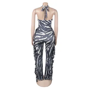 Back view of elegant zebra print halter neck jumpsuit with side fringe details and flared legs