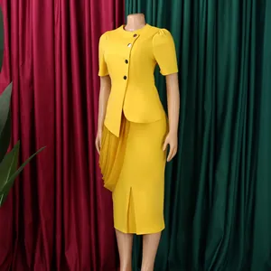 Close-up detail of yellow elegant peplum top and pencil skirt two-piece set with tulle