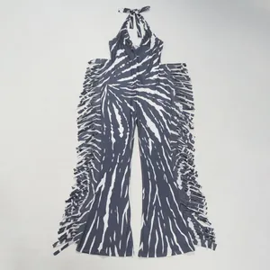 Elegant halter neck jumpsuit featuring abstract print and side fringe details in grey