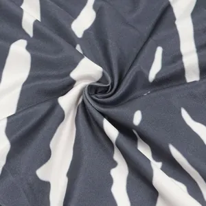 Close-up detail of high-elasticity fabric with black and white zebra stripe print.