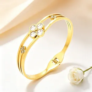 Elegant gold stainless steel clover bangle bracelet with sparkling rhinestones