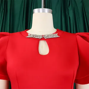 Detail of red evening dress featuring rhinestone neckline and keyhole cutout design
