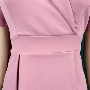 Macro detail of elegant pink plus size dress highlighting fabric texture and waistline