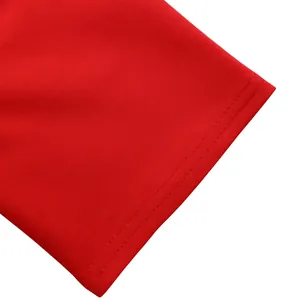 Detail view of the refined stitching and red fabric texture for African suit set