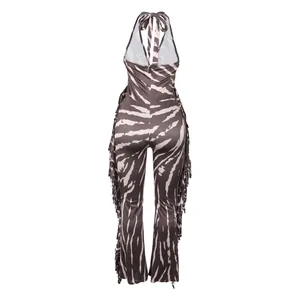 Detailed back view of a zebra print halter jumpsuit with fringe details and flared legs