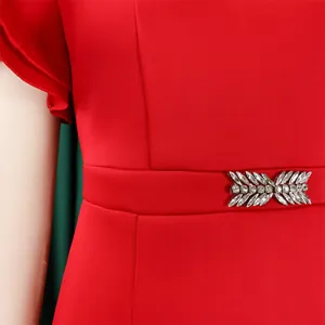 Close-up of sparkling rhinestone embellishment on a red cocktail dress waist