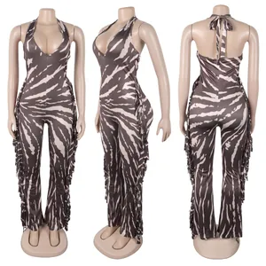 Detailed front, side and back views of a zebra print halter jumpsuit with fringe accents.