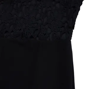 Close-up of intricate black lace and high-waisted fabric detail on a jumpsuit