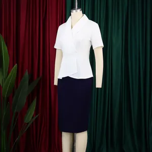 Detail view of an elegant white and navy color block peplum bodycon dress on mannequin
