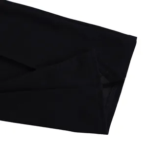 Macro detail view showing high-quality overlock stitching on black fabric jumpsuit hem
