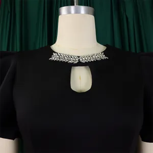 Detailed macro view of rhinestone leaf embellishments and keyhole cutout on party dress