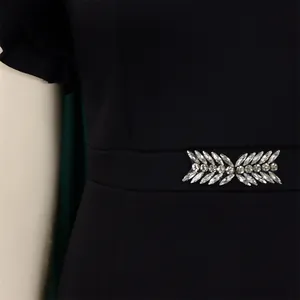 Close-up of rhinestone wheat ear pattern on a black bodycon party dress waist
