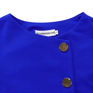 Close-up view of royal blue elegant top neckline with gold buttons and fabric detail