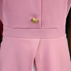 Primo piano della vita di un abito rosa con bottone dorato e raffinato design a spacco